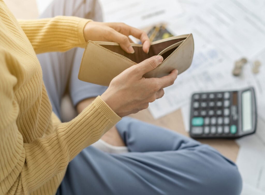 woman holding empty wallet