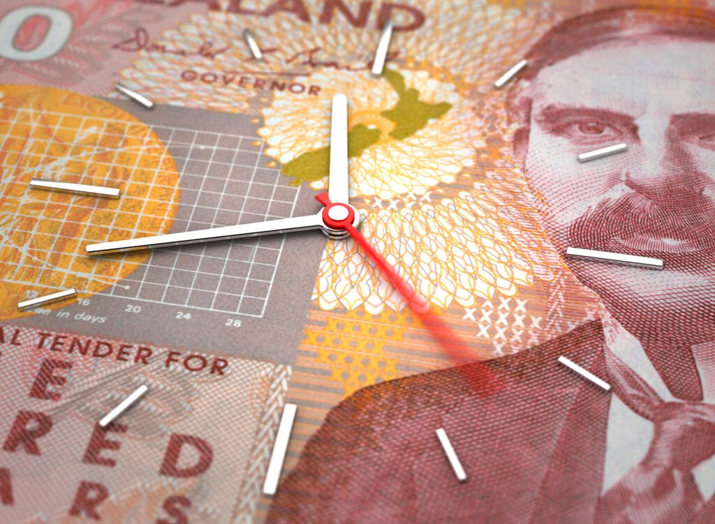 image of clock overlayed onto new zealand hundred dollar note